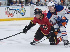 Edmonton Oilers Kailer Yamamoto tries to get around Calgary Flames Adam Ollas Mattsson while chasing a loose puck during the NHL Young Stars Classic hockey action at the South Okanagan Events Centre in Penticton, BC, September, 8, 2017.