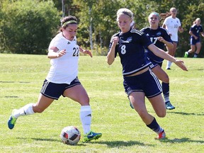 Michelle Walsh, left, of Laurentian Voyageurs, battles for the ball with Abby Wroe, of Nipissing Lakers, during soccer action at Laurentian University in Sudbury, Ont. on Saturday September 9, 2017. John Lappa/Sudbury Star/Postmedia Network