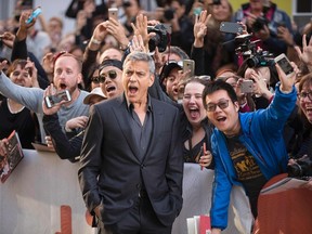 George Clooney poses with fans at the premiere of "Suburbicon" at the Toronto International Film Festival in Toronto, Ontario, September 9, 2017. (Geoff Robins/Getty Images)