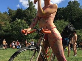 Olivia Neely, a topless cyclist wearing body paint, motions before the start of the annual Philly Naked Bike Ride in Philadelphia on Saturday Sept. 9, 2017. (AP Photo/Dino Hazell)