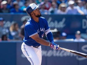 Teoscar Hernandez watches one of his two home runs clear the wall at the Rogers Centre on Sunday. (Chris Young, Canadian Press)