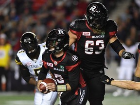Redblacks quarterback Drew Tate runs with the ball against the Tiger-Cats. Tate, who is in his ninth CFL season, has the confidence of the coaching staff that he can get the job done. (The Canadian Press)