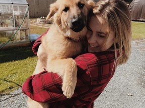 Celeste Papineau embraces Kodak, a five-month old dog who went missing in the woods for a week after being ejected in an ATV crash on Sand Bay Road, about five kms south of Agnew Lake, where the Papineau family has a camp. The dog has a broken paw and other ailments but is expected to recover. (Catherine Demers/For The Sudbury Star)