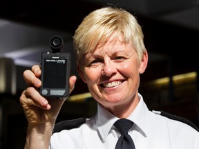 Deputy Chief Danielle Campbell holds up a police body worn camera during an Edmonton Police Service news conference at EPS Headquarters in Edmonton, Alta., on Tuesday June 23, 2015. Ian Kucerak/Edmonton Sun/Postmedia Network