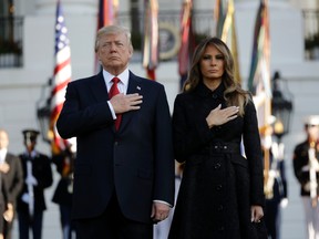 President Donald Trump and first lady Melania Trump stand for a moment of silence to mark the anniversary of the Sept. 11 terrorist attacks, on the South Lawn of the White House, Monday, Sept. 11, 2017, in Washington. (AP Photo/Evan Vucci)