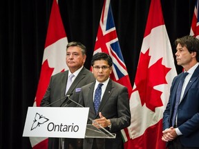 Attorney General Yasir Naqvi, centre, Minister of Finance Charles Sousa, left, and Minister of Health and Long-Term Care Eric Hoskins speak during a press conference where they detailed Ontario's solution for recreational marijuana sales, in Toronto on Friday, September 8, 2017. (THE CANADIAN PRESS/Christopher Katsarov)