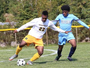 Augustus Oku, left, of Cambrian College, attempts to get by a Sheridan College player during soccer action at Cambrian College in Sudbury, Ont. on Saturday September 9, 2017. John Lappa/Sudbury Star/Postmedia Network