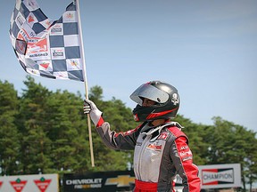 Junior Lindgren waves the checkered flag after winning the Briggs Junior national title in Bowmanville on Aug. 27. Canadian Karting news photo