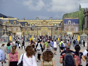 Tourists walk towards the palace of Versailles, on August 3, 2011 in the French town of Versailles, a southwestern suburb of Paris. Some 15 millions visit each year the gardens of Versailles and some 6 millions others visit the palace itself. AFP PHOTO / MIGUEL MEDINA (Photo credit should read MIGUEL MEDINA/AFP/Getty Images)