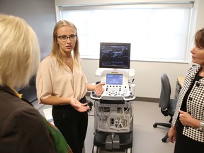 Elliot Ferguson/The Whig-Standard
Research assistant Kiera Liblik explains the use of an ultrasound machine to view a carotid artery at the grand opening of the W.J. Henderson Centre for Patient-Oriented Research at Kingston Health Sciences Centre on Monday.