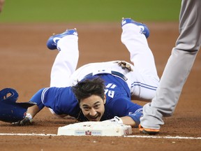 Darwin Barney of the Toronto Blue Jays crawls into third base after stumbling in the second inning during MLB action against the Baltimore Orioles at Rogers Centre on Sept. 11, 2017. (Tom Szczerbowski/Getty Images)