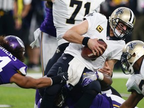 New Orleans Saints quarterback Drew Brees is sacked by Minnesota Vikings middle linebacker Eric Kendricks, left, during the first half of an NFL football game on Sept. 11, 2017. (AP Photo/Jim Mone)