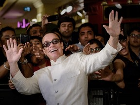 Belgium born actor Jean Claude Van Damme strikes a pose during the 14th International Indian Film Academy (IIFA) in Macau on July 6, 2013. The annual IIFA Awards, India's Hindi language film industry, Bollywood's glitziest awards ceremony, which have been held overseas for the last 13 years, is one of the world's most-watched annual entertainment ceremonies, broadcast to nearly 500 million viewers in 110 countries. AFP PHOTO/Philippe Lopez (Photo credit should read PHILIPPE LOPEZ/AFP/Getty Images)