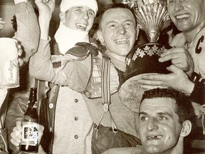 Jubilant members of the Belleville McFarlands celebrate with the Allan Cup in 1958 in Kelowna, BC, after claiming the national senior hockey title. From left are Davey Jones, Ike Hildebrand, Russ Kowalchuk and team captain Floyd Crawford. (Hockey Canada)