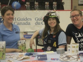 The local chapter of Girl Guides of Canada sits at their table at the Community Connections event on Sept. 7. From left to right: Alissa Wilson, Catherine Macdonald and Jolie Camps (Joseph Quigley | Whitecourt Star).