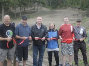 Members of the Whitecourt Mountain Bike Association and local mayors cut the ribbon for the grand opening of the new mountain bike park on Sept. 9. From left to right: Mike Braun, Mike Penner, Jim Rennie, Maryann Chichak, Darrel Strebchuk, Dan Bryant and Beth Penner (Joseph Quigley | Whitecourt Star).