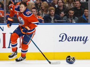 Edmonton's Jesse Puljujarvi (98) looses his helmet battling Ottawa's Mark Stone (61) during the first period of a NHL game between the Edmonton Oilers and the Ottawa Senators at Rogers Place in Edmonton on Oct. 30, 2016.