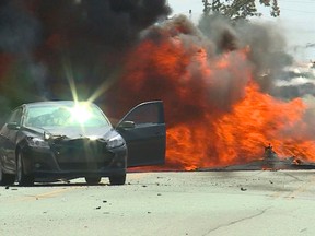 A single-engine plane bursts into flames after it crashed into a neighborhood in Roy, Utah, Tuesday, Sept. 12, 2017. (Winston Armani/The Deseret News via AP)