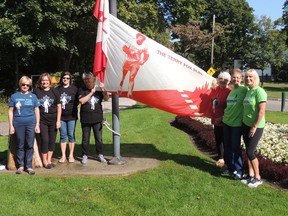 Volunteers raise the flag in preparation for Sunday's Terry Fox Walk/Run in Canatara Park. From left are Cathy Aitkin, Cindy Melton, Rosi Farina, Jo Kulik, Betty Dee Black, Suzanne Schofield and run commitee chair Laurie Rome.SUBMITTED PHOTO