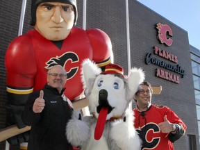 Calgary Flames President and CEO Ken King joins Harvey the Hound and Mayor Naheed Nenshi in 2011 to officially open the new sheet of ice at the Flames Community Arenas.
