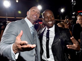 Dwayne 'The Rock' Johnson (L) and recording artist/actor Tyrese Gibson attend Universal Pictures' 'Furious 7' premiere at TCL Chinese Theatre on April 1, 2015 in Hollywood, California. (Photo by Alberto E. Rodriguez/Getty Images)