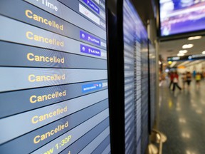 In this Sept. 8, 2017, file photo, a monitor is shown listing cancelled flights at Miami International Airport in Miami. In addition to residents affected by Hurricane Irma in Florida and the Caribbean, thousands of travelers' vacation plans have been disrupted by cancelled flights, cruises that changed course and hotels and attractions that closed or were damaged by the storm. (Wilfredo Lee/AP Photo, File