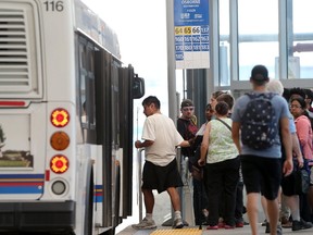 Winnipeg transit users board a bus.