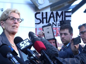Premier Kathleen Wynne speaks to media at a courthouse in Sudbury on Sept. 13. The premier was testifying  at the trial of Pat Sorbara, her former deputy chief of staff, and Gerry Lougheed, a local Liberal organizer, both of whom faced charges under the Election Act. (Gino Donato/Sudbury Star file photo)