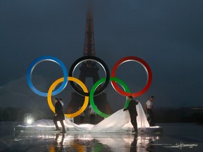 Paris officials unveil a display of the Olympic rings on Trocadero plaza that overlooks the Eiffel Tower, after the vote in Lima, Peru, awarding the 2024 Games to the French capital, in Paris, France, Wednesday, Sept. 13, 2017. (AP Photo/Francois Mori)
