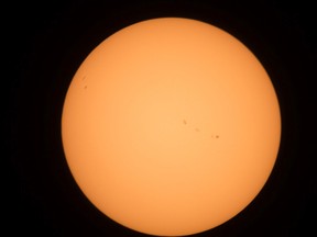 The partial solar eclipse is observed at an event held by the Royal Astronomical Society at the Canadian Aviation and Space Museum in Ottawa on Aug. 21, 2017. (Wayne Cuddington/Postmedia Network)