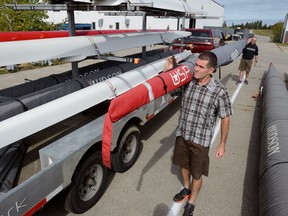 Craig McAllister, left, and Hugh Hudson load shells on a trailer for delivery to the World Rowing Championships in Sarasota, Fla., at Hudson Boat Works in London Wednesday. (MORRIS LAMONT/THE LONDON FREE PRESS)
