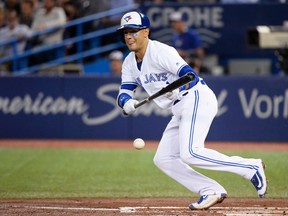 Toronto Blue Jays second baseman Ryan Goins lays down a sacrifice bunt against the Baltimore Orioles during MLB action in Toronto on Sept. 13, 2017. (THE CANADIAN PRESS/Nathan Denette)