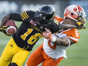 Hamilton Tiger-Cats' Brandon Banks pushes off off BC Lions defensive back T.J. Lee during CFL action in Hamilton, Ont., on July 15, 2017. (THE CANADIAN PRESS/Peter Power)