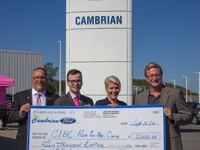 Claudio Roberti, left, business development manager of CIBC, Justin Burns, community fundraising specialist at the Canadian Cancer Society, Michelle Caza Joly, vice-president of Cambrian Ford, and Scott McCulloch, president of Cambrian Ford, take part in a cheque presentation at the dealership. Supplied photo