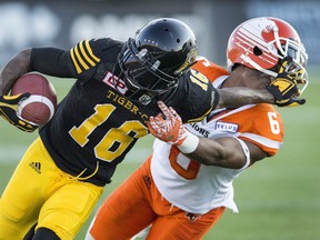 Hamilton Tiger-Cats’ Brandon Banks (16) pushes off off B.C. Lions defensive back T.J. Lee in Hamilton on Saturday, July 15, 2017. (THE CANADIAN PRESS/Peter Power)