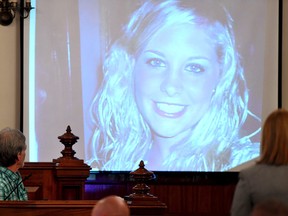 Dana Bobo looks up at a photo of his daughter, Holly Bobo, as it is displayed on an overhead projector during his testimony in Zachary Adams’ trial Monday, Sept. 11, 2017, in Savannah, Ga. (Kenneth Cummings/The Jackson Sun via AP)