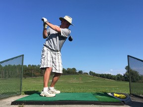 Rick Wanless tees off at the Belle Park driving range in Kingston, Ont. on Thursday, Sept. 14, 2017. A city report recommends scaling back golf activities at the site, in favour of walking trails, rugby and pickleball. Elliot Ferguson/The Whig-Standard/Postmedia Network