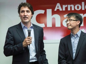Then-Federal Liberal Leader Justin Trudeau speaks to supporters as he visits Liberal candidate for Scarborough-Agincourt Arnold Chan (right) at his campaign office in Toronto on Wednesday, May 21, 2014. Chan has died of cancer. (THE CANADIAN PRESS/FILES)