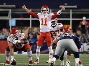 In this Sept. 7, 2017, file photo, Kansas City Chiefs quarterback Alex Smith calls signals at the line of scrimmage during the first half of an NFL football game against the New England Patriots, in Foxborough, Mass. (AP Photo/Steven Senne, File)
