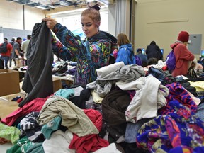 Shyenne Bice looking at clothes as youth between the ages of 13 and 29 experiencing housing insecurity or homelessness, were offered a variety of services and help from agencies during the 4th Annual YEG Youth Connect at the Boyle Street Plaza in Edmonton, September 14, 2017. Ed Kaiser/Postmedia