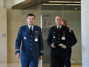 Lt. Gen. Pierre St-Amand, left, arrives to appear as a witness at a commons national defence committee in Ottawa on Thursday, Sept. 14, 2017. The committee is hearing witnesses on Canada's abilities to defend itself and our allies in the event of an attack by North Korea on the North American continent. (THE CANADIAN PRESS/Sean Kilpatrick)
