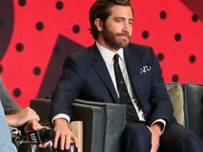 Jake Gyllenhaal (L) places his hand on Jeff Bauman's knee after the cast was asked about a bromance during the press conference for the movie Stronger at the Toronto International Film Festival in Toronto on Saturday September 9, 2017. Veronica Henri/Toronto Sun/Postmedia Network