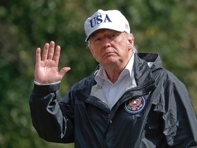 President Donald Trump waves as he arrives at the White House, Thursday, Sept. 14, 2017, in Washington. Trump is returning from Florida after viewing damage from Hurricane Irma. (AP Photo/Alex Brandon)