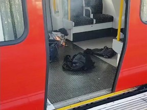 This is an image made from video showing burning items in underground train at the scene of an explosion in London Friday, Sept. 15, 2017. A reported explosion at a train station sent commuters stampeding in panic, injuring several people at the height of London's morning rush hour, and police said they were investigating it as a terrorist attack. (Sylvain Pennec via AP)