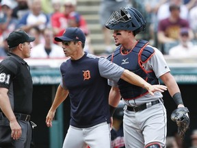 Detroit Tigers manager Brad Ausmus, centre, and catcher James McCann argue with home plate umpire Quinn Wolcott during Wednesday, Sept. 13, 2017, in Cleveland. (AP Photo/Ron Schwane)