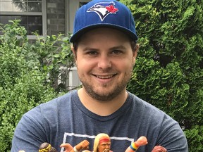 Mark Butcher holds three of his favourite vintage wrestling toys, part of his massive collection of the 1980s collectibles, outside of his home. Featured are the late Macho Man Randy Savage, left, Hulk Hogan, middle, and the late Ultimate Warrior. (Jan Murphy/Postmedia Network)