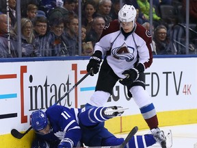 Zach Hyman of the Toronto Maple Leafs gets hit by Nikita Zadorov of the Colorado Avalanche at the Air Canada Centre in Toronto on Dec. 11, 2016. (Dave Abel/Toronto Sun/Postmedia Network)