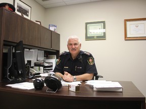 Aylmer Police Chief Andre Reymer sits at his desk in the Aylmer Police station. He is retiring at the end of the year after 30 years with the force. (Laura Broadley/Times-Journal)