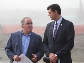Mayor Don Iveson (right) and Brian Mason, NDP MLA for Edmonton-Highlands-Norwood, minister of Transportation and minister of Infrastructure, speak to each other at a funding announcement for the Southeast Valley Line LRT in a construction area near 75 Street and Whitemud Drive in Edmonton, Alta. on Friday, Sept. 15, 2017. Claire Theobald/Postmedia