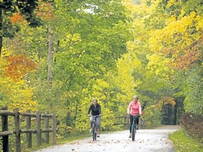 Wilma Dykstra and Mary-Anne Cross of St. Thomas ride through the fall colours along the Thames River in London. (MIKE HENSEN, The London Free Press file photo)